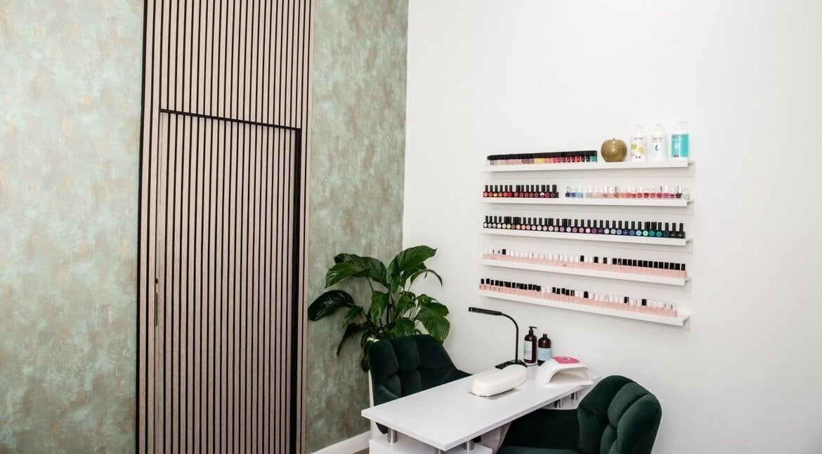 Elegant nail salon corner at Probeaute, Marbella, Andalucía, ES featuring polish displays and plush seating.