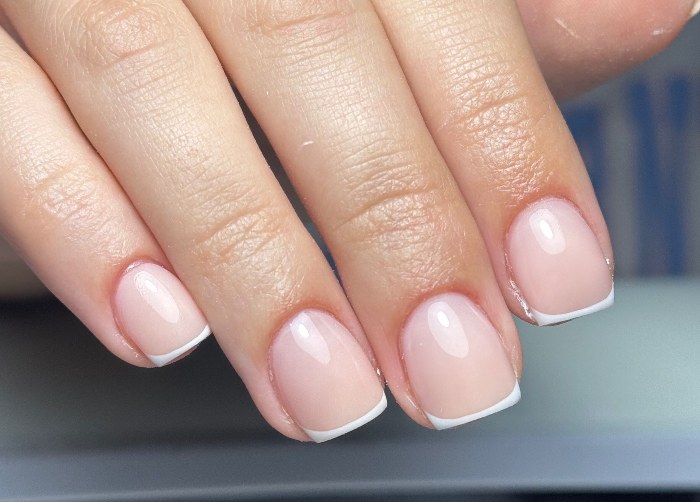 Close-up of a French manicure at B's Nail Lounge, Cartwirght, New South Wales, AU showcasing pristine nail art.