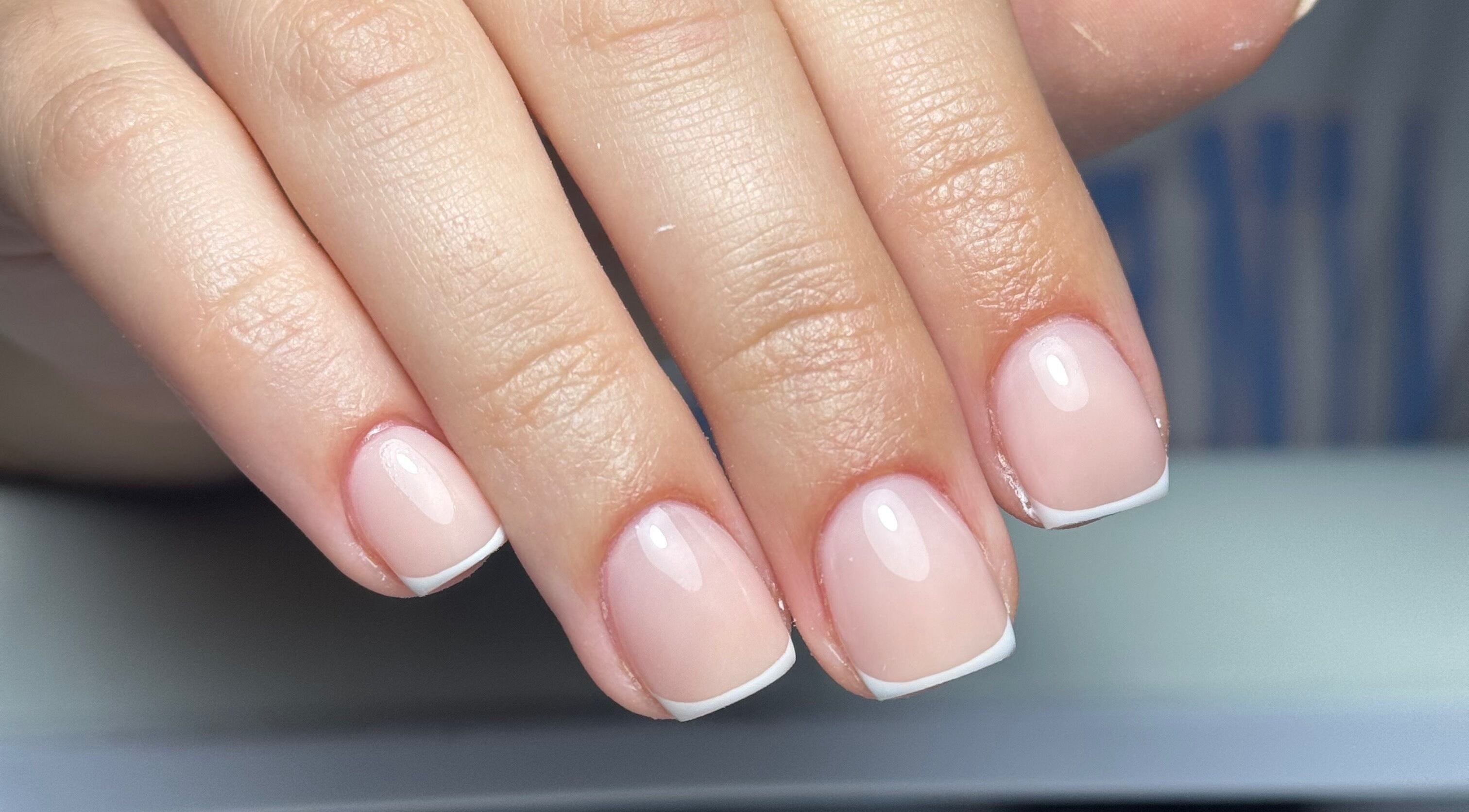 Close-up of a French manicure at B's Nail Lounge, Cartwirght, New South Wales, AU showcasing pristine nail art.