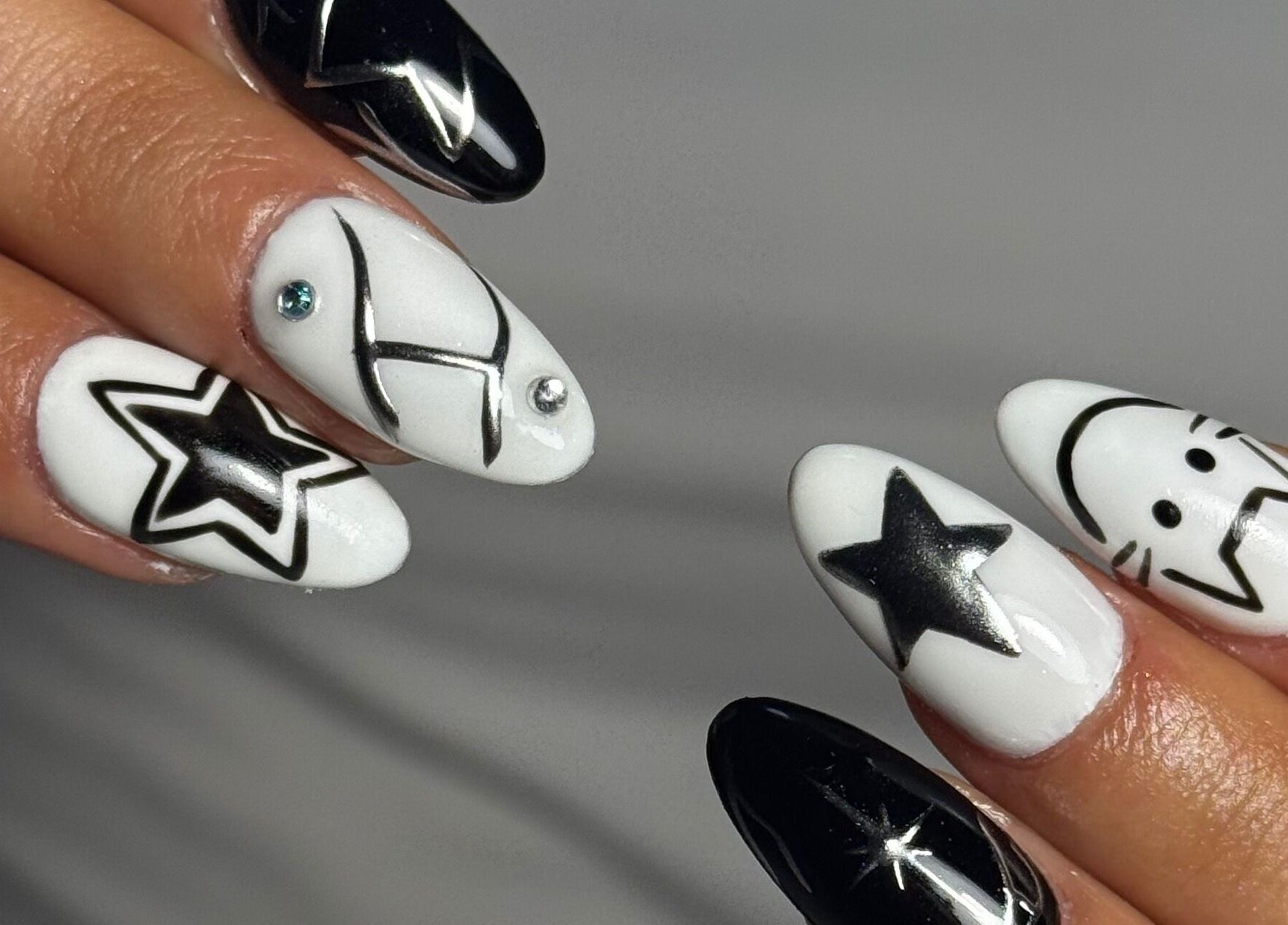 Stylish black and white star nail art at B's Nail Lounge in Cartwright, New South Wales, AU.
