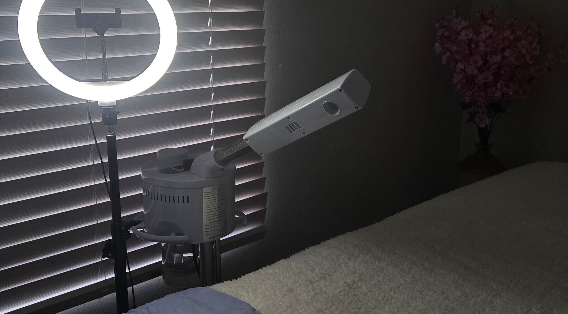 Relaxing spa room at Whispering Waters, Bloemfontein, Free State, ZA, featuring a ring light and massage bed.