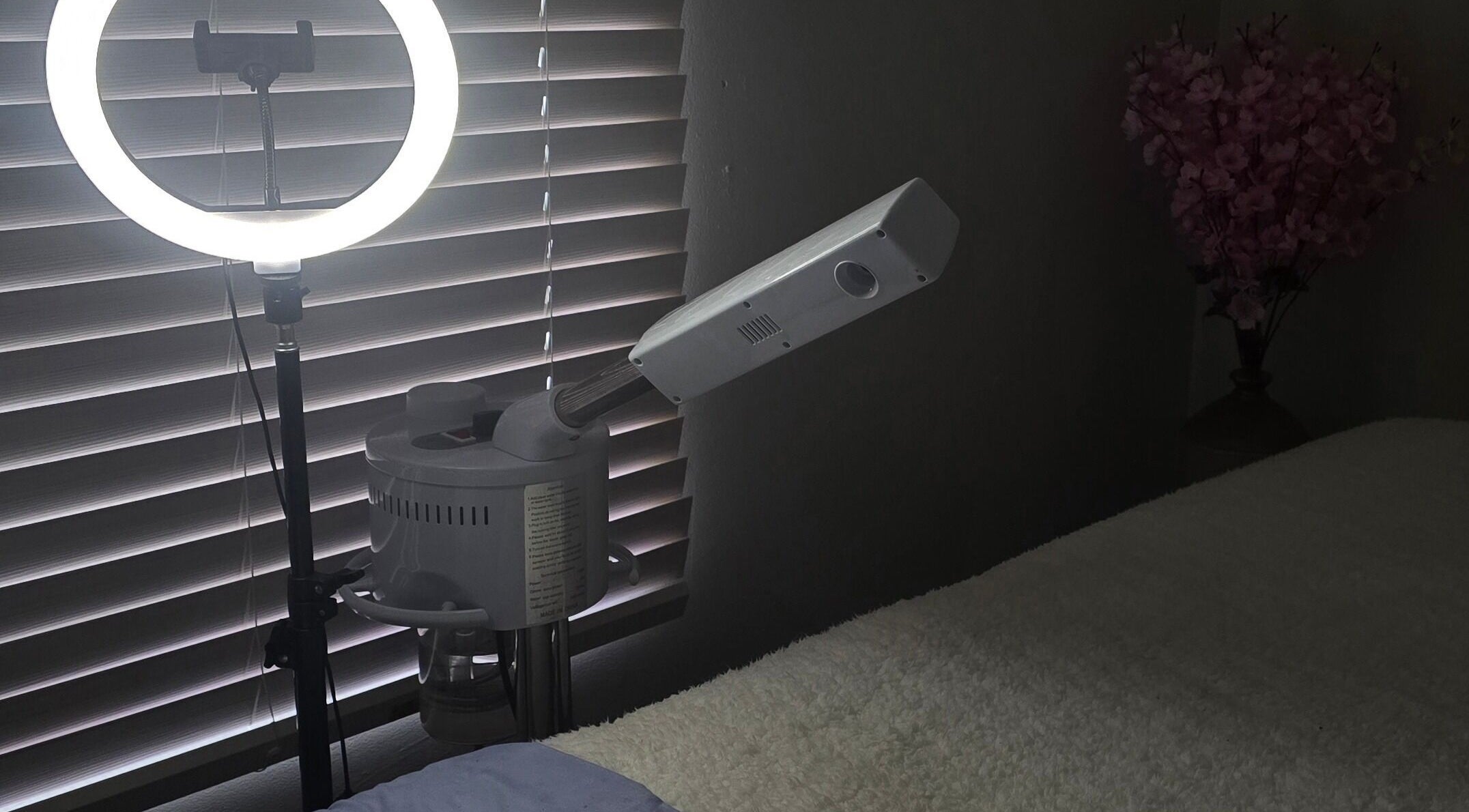 Relaxing spa room at Whispering Waters, Bloemfontein, Free State, ZA, featuring a ring light and massage bed.