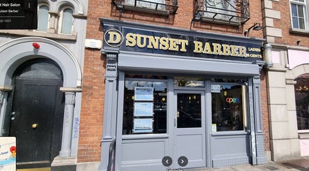 Entrance of Sunset Barber Salon at Dublin 1, County Dublin, IE. Classic facade with vibrant signage.