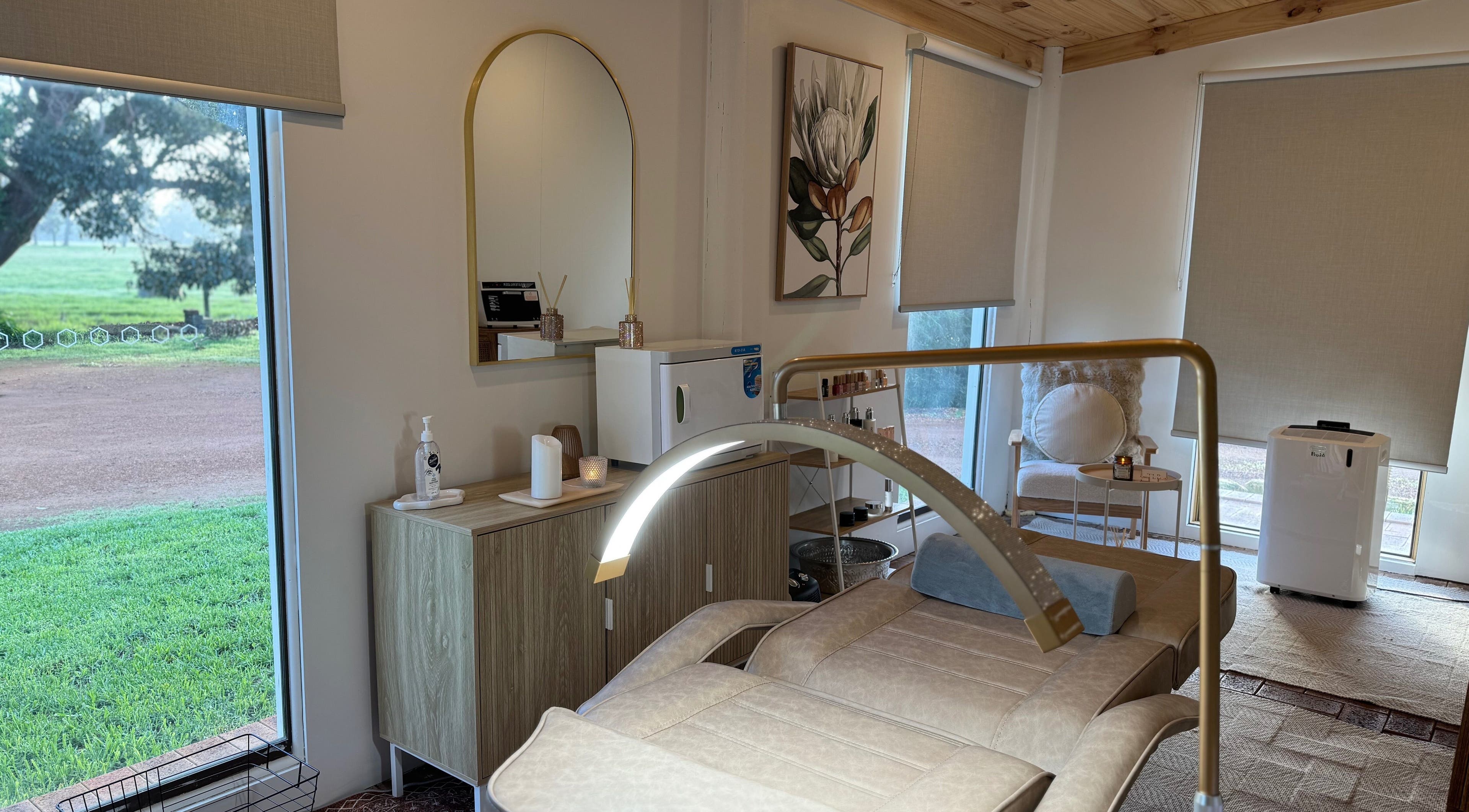 Luxurious spa room at Tiarne Lauren Beauty, Vasse, Western Australia, AU, featuring elegant decor and a massage bed.
