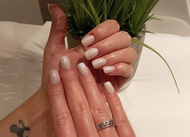 Manicured hands with glossy nails at Priscillas Beauty Spot, Pretoria, Gauteng, ZA.