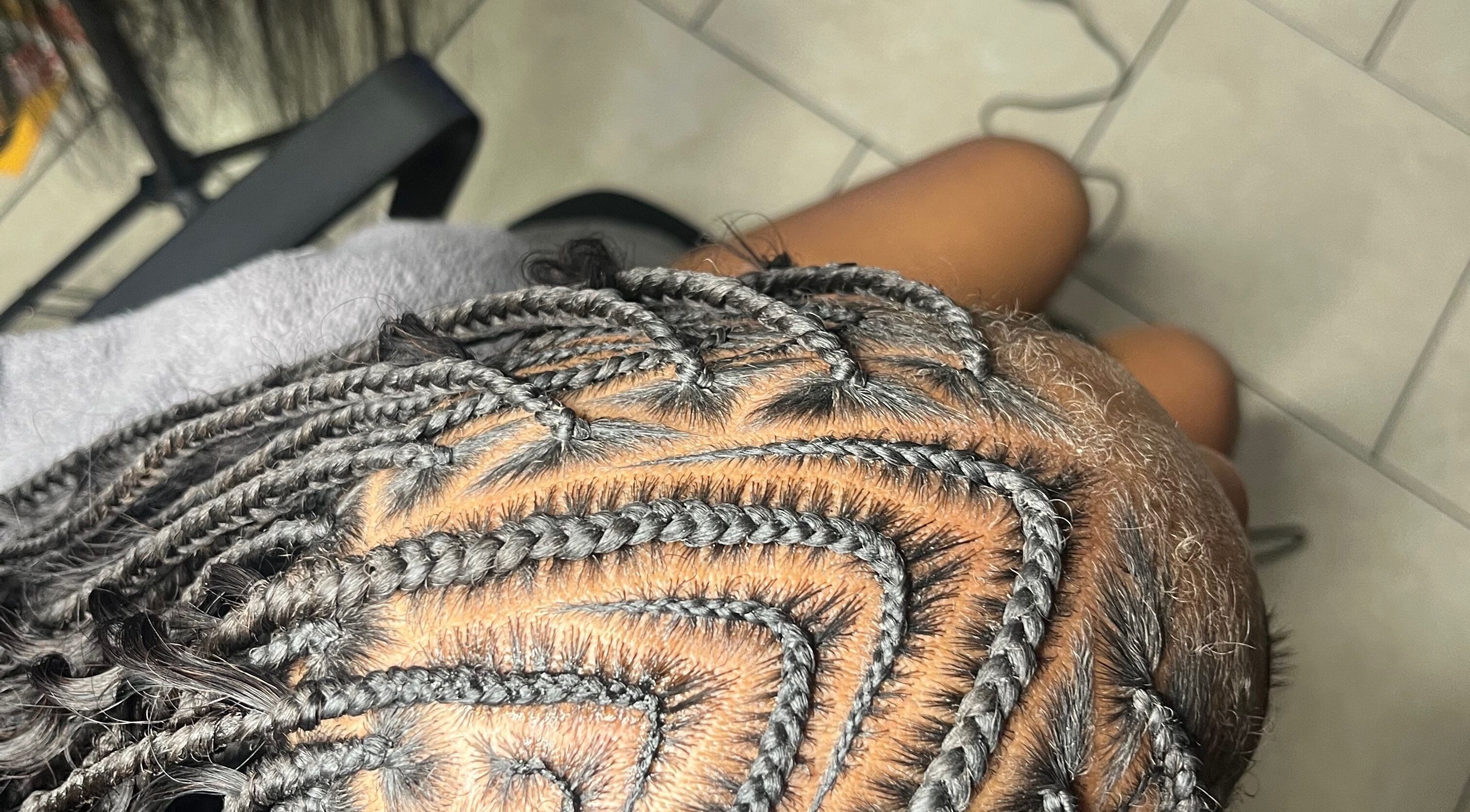 Close-up of intricate braids at Berry’s Roots in Opa-locka, Florida, US, showcasing expert hairstyling.