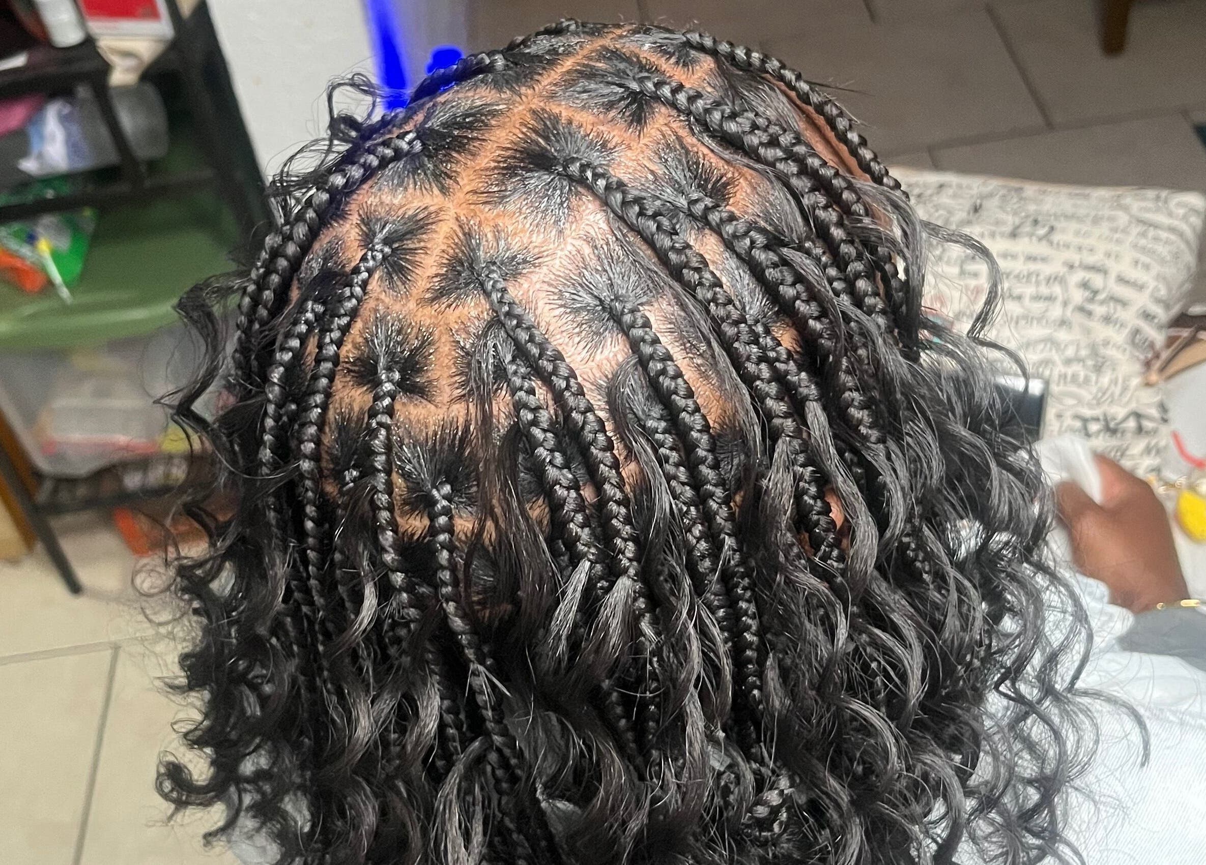 Intricate braid hairstyle at Berry’s Roots, Opa-locka, Florida, US, showcasing professional hairstyling.