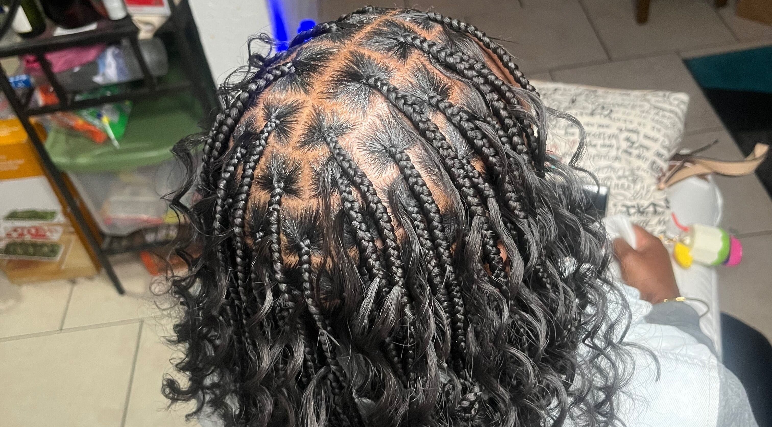 Intricate braid hairstyle at Berry’s Roots, Opa-locka, Florida, US, showcasing professional hairstyling.