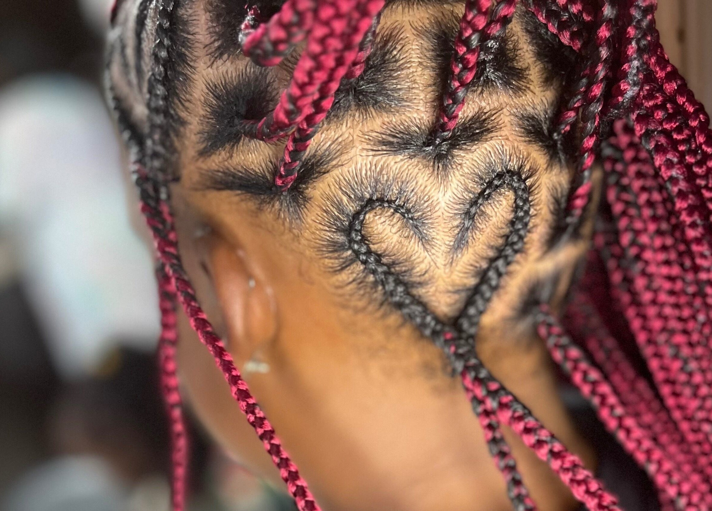 Heart-shaped braid design at Berry’s Roots, Opa-locka, Florida, US, showcasing unique hairstyling.
