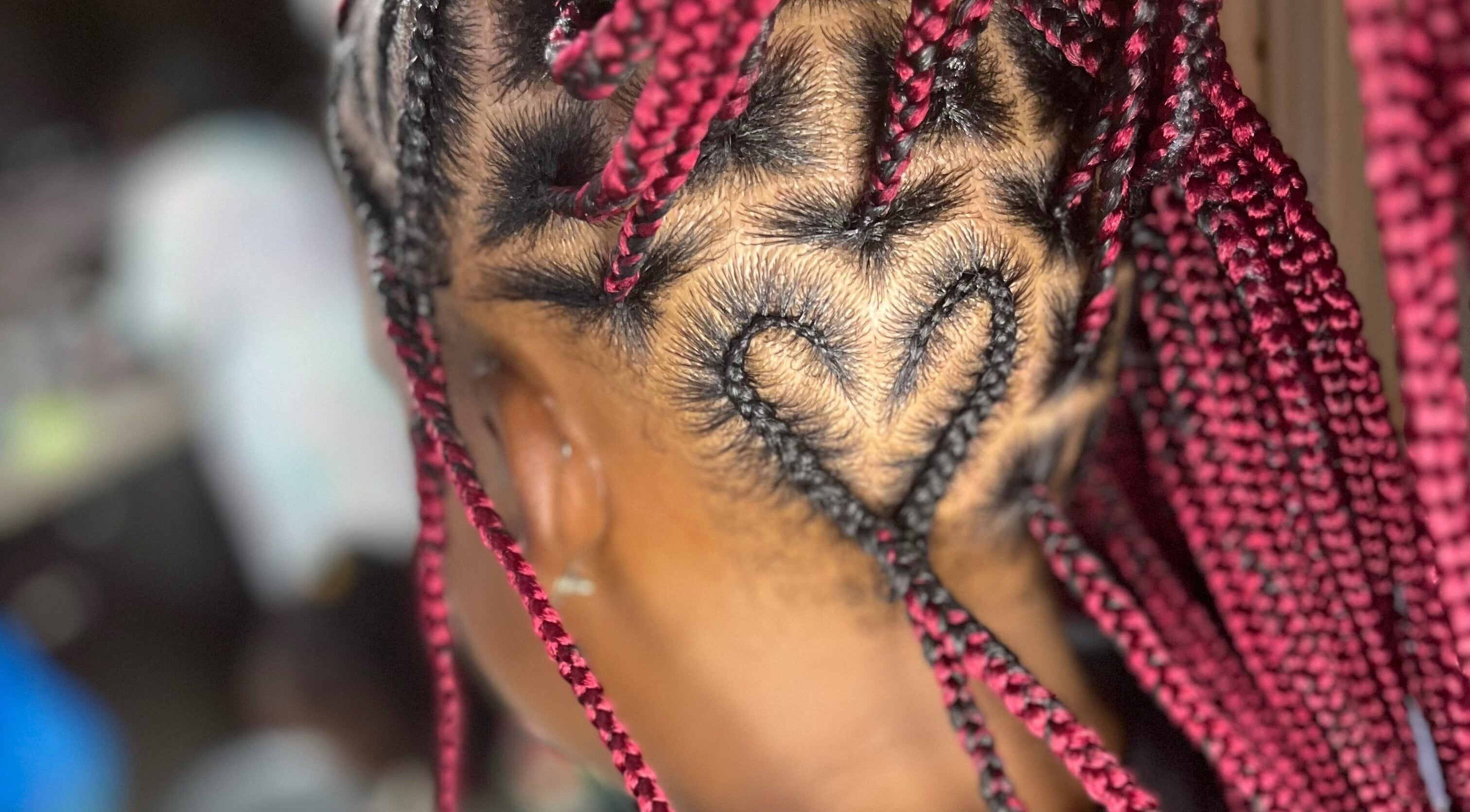 Heart-shaped braid design at Berry’s Roots, Opa-locka, Florida, US, showcasing unique hairstyling.