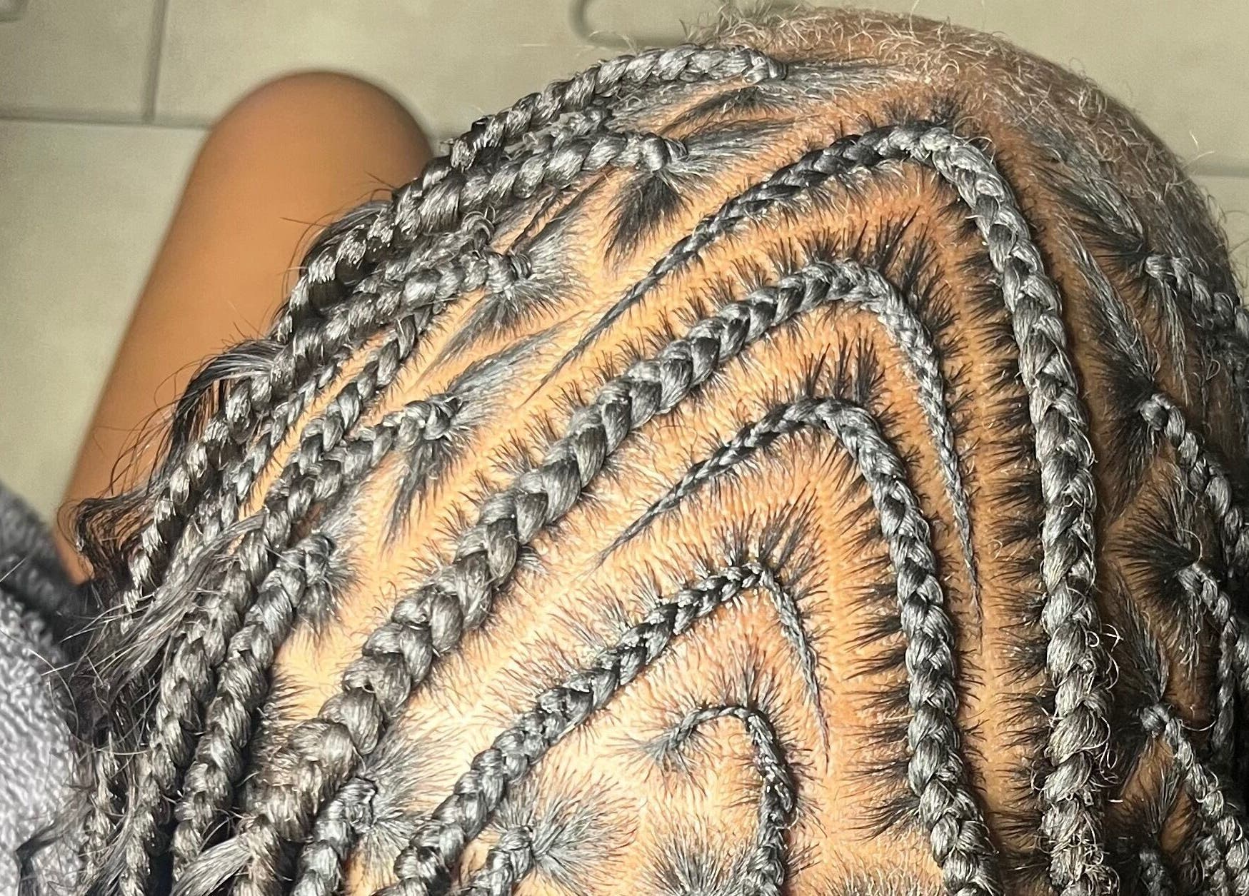 Intricate braided hairstyle at Berry’s Roots in Opa-locka, Florida, US, showcasing expert craftsmanship.