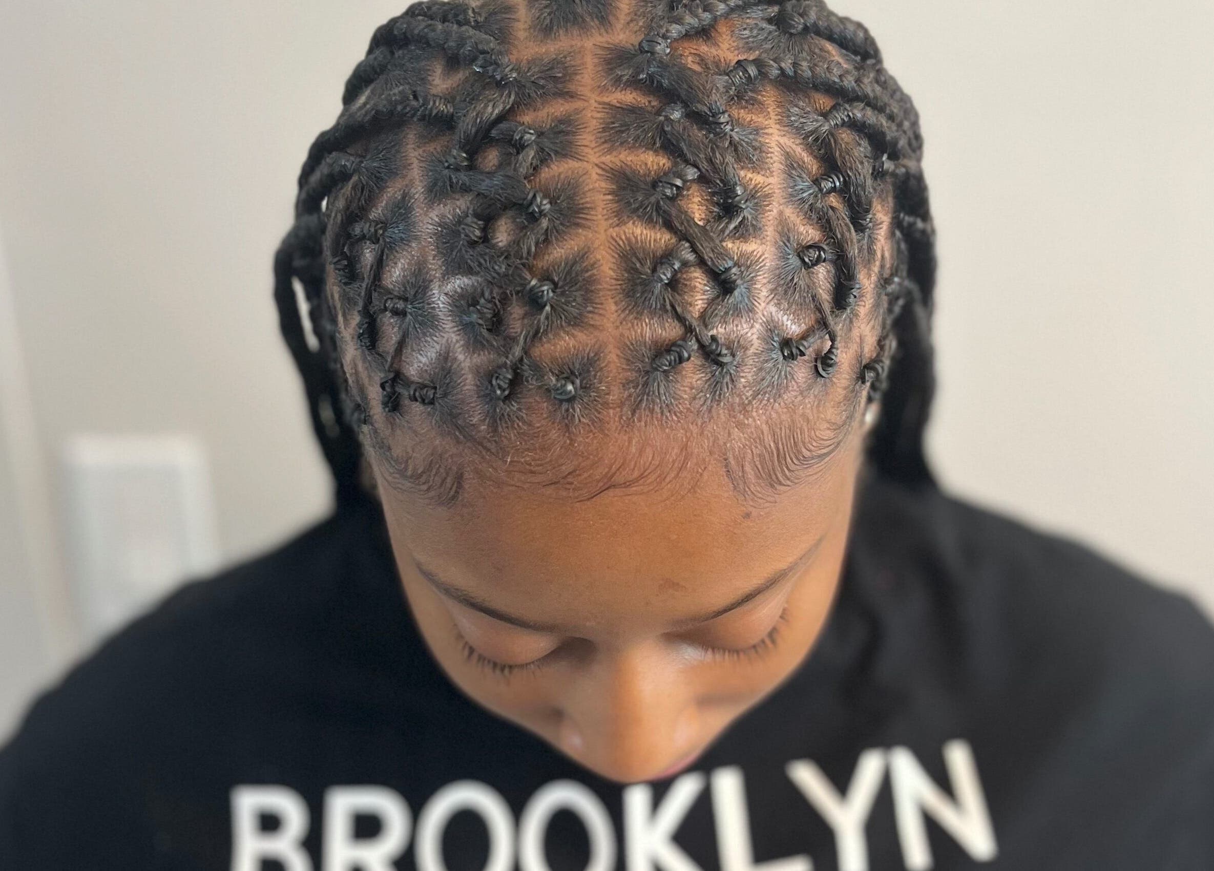 Intricate braided hairstyle at Berry’s Roots in Opa-locka, Florida, US.