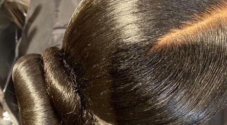 Elegant, shiny bun hairstyle at Natural Beauty by Jeanette, Charlotte, North Carolina, US.