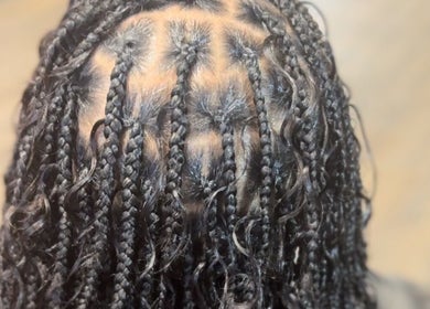 Intricate braiding style at Natural Beauty by Jeanette in Charlotte, North Carolina, US.