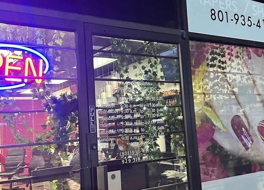 W2 salon entrance with neon open sign at South Salt Lake, Utah, US showcasing elegant nail art.