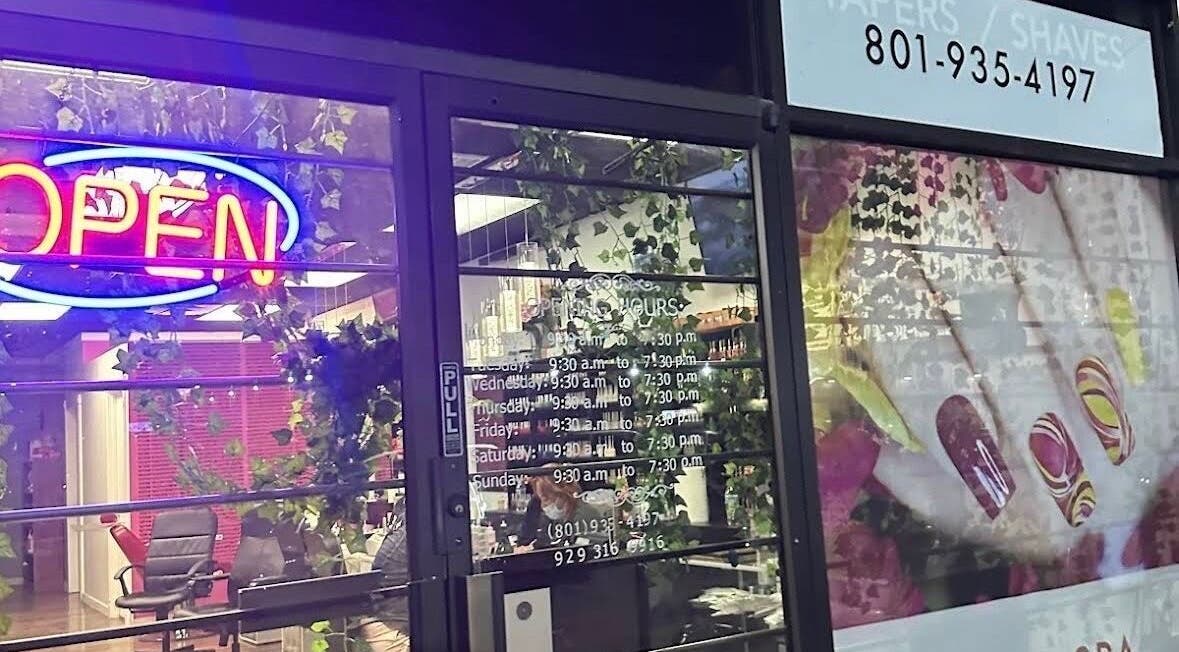 W2 salon entrance with neon open sign at South Salt Lake, Utah, US showcasing elegant nail art.