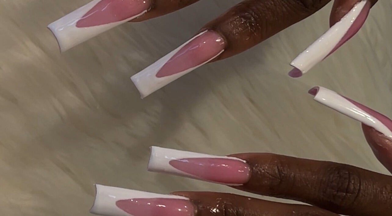 Stylish pink and white nails at Acrylidelic, Tallahassee, Florida, US, showcasing artistic nail design.