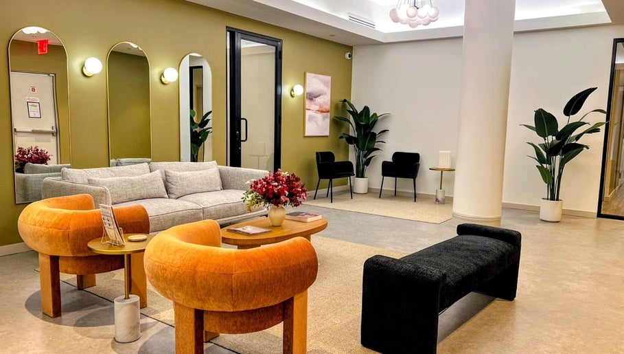 Relaxing lounge area at Laser 'n' Beyond - Chelsea NYC, New York, with modern decor and plush seating.