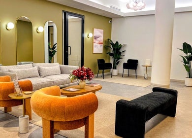 Relaxing lounge area at Laser 'n' Beyond - Chelsea NYC, New York, with modern decor and plush seating.