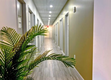 Bright hallway at Laser 'n' Beyond - Chelsea NYC, New York, New York, US, with modern design and plant decor.