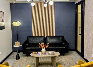 Elegant lounge at Laser 'n' Beyond - Chelsea NYC, featuring a comfy sofa and chic decor in New York, US.