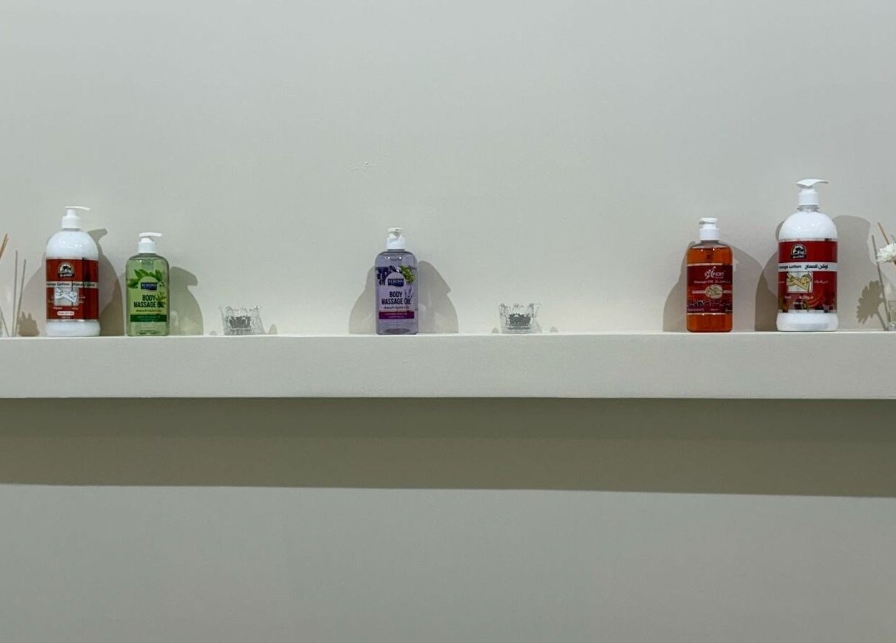 Selection of massage oils on a shelf at Tawazun Spa, Riyadh, Riyadh Province, SA providing relaxation ambiance.