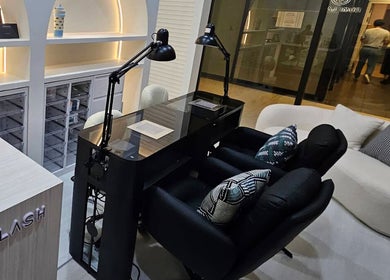 Modern salon interior at Dumi Lash, Singapore, SG, showcasing sleek workspace and comfortable seating.