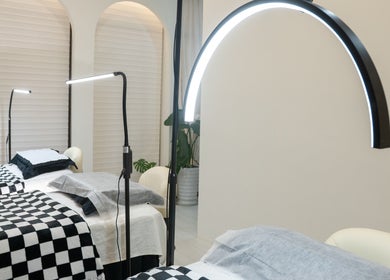 Elegant treatment beds at Dumi Lash, Singapore, SG offer a serene beauty experience.