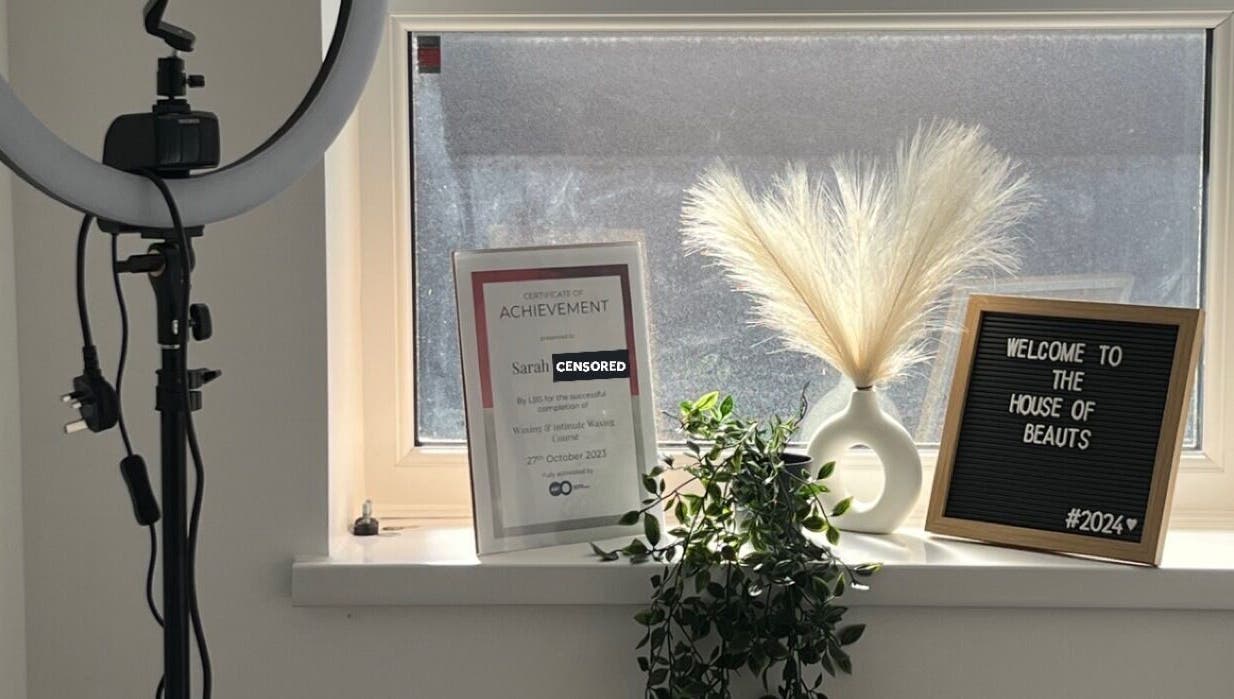 Welcome sign and certificate at The House of Beauts, Barking, England, GB, showcasing a chic, inviting interior.