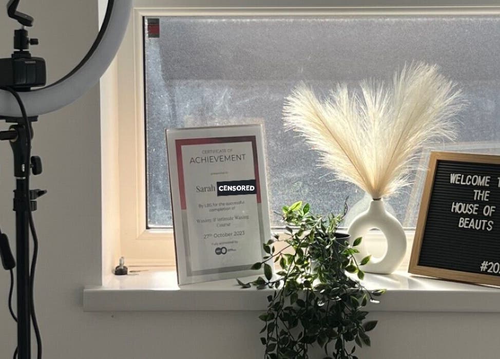 Welcome sign and certificate at The House of Beauts, Barking, England, GB, showcasing a chic, inviting interior.