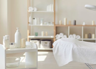 Tranquil treatment room at Royal York Holistic Med Spa in Toronto, Ontario, CA with white towels and products.