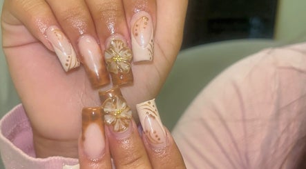 Intricate floral nail art at Nails by Frankie in Chicago, Illinois, US showcasing delicate brown designs.