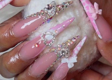 Intricate pink and gem-studded nail art by Nails by Frankie, Chicago, Illinois, US.