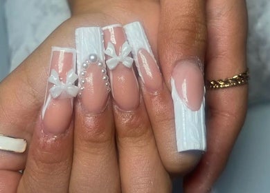 Intricate white nail art design at Nails by Frankie, Chicago, Illinois, US, showcasing elegance and style.