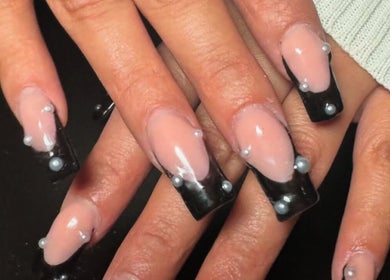 Chic black and pearl nail art at Nails by Frankie in Chicago, Illinois, US. A modern, bold manicure style.