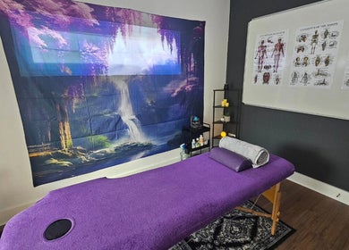 Cozy therapy room at Rejuvenating Therapies, Bangor, Northern Ireland, GB with a purple massage table and soothing decor.