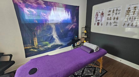 Cozy therapy room at Rejuvenating Therapies, Bangor, Northern Ireland, GB with a purple massage table and soothing decor.