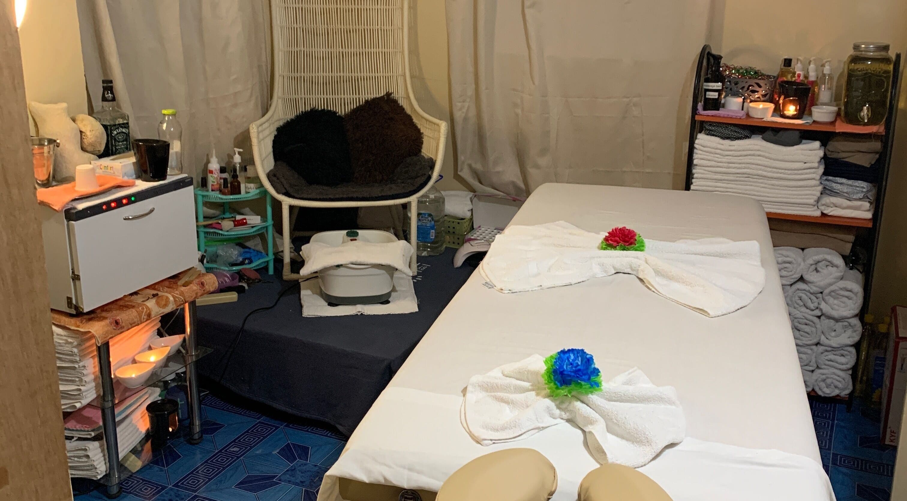 Cozy massage room at Glam Harmony Day Spa in Dennery, LC, featuring a treatment table and relaxing ambiance.
