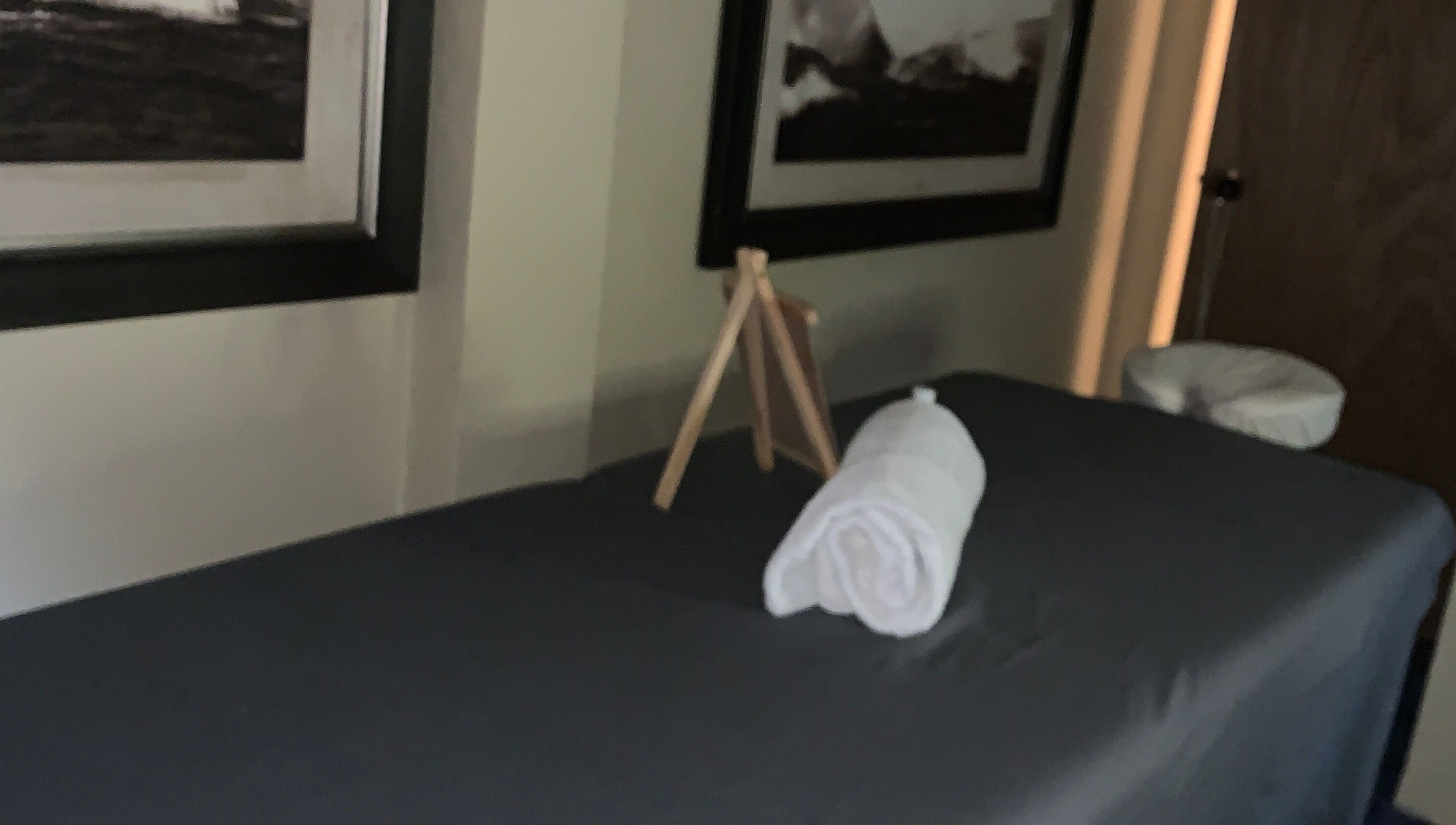 Relaxing massage room at Glam Harmony Day Spa, Dennery, LC, featuring a cozy treatment bed and calming decor.