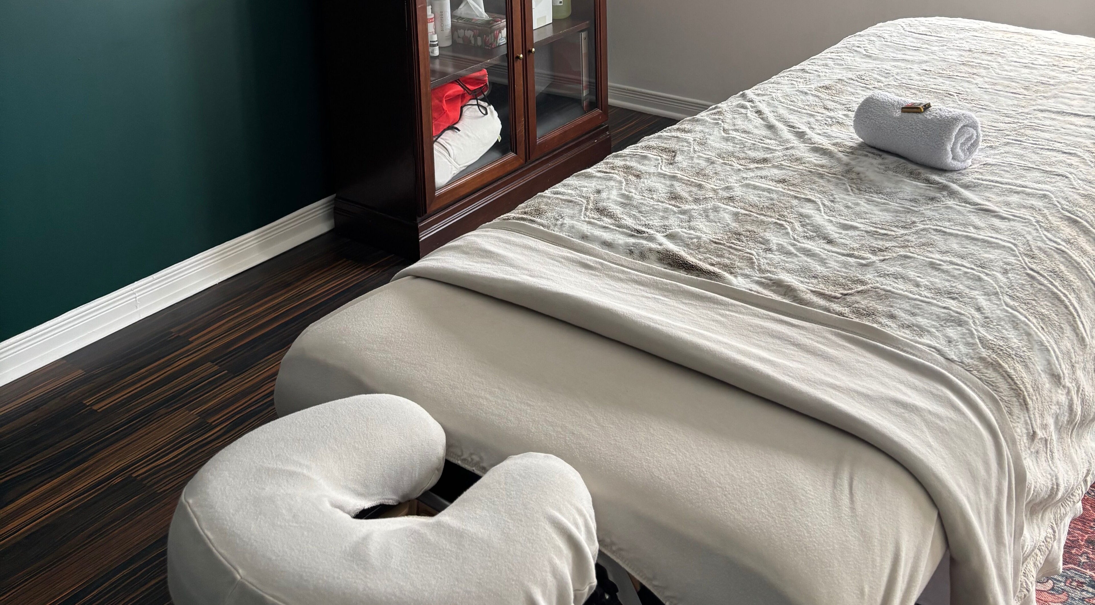 Relaxing massage room at Aylmer / Plateau, Gatineau, Québec, CA, featuring a cozy massage bed and warm decor.