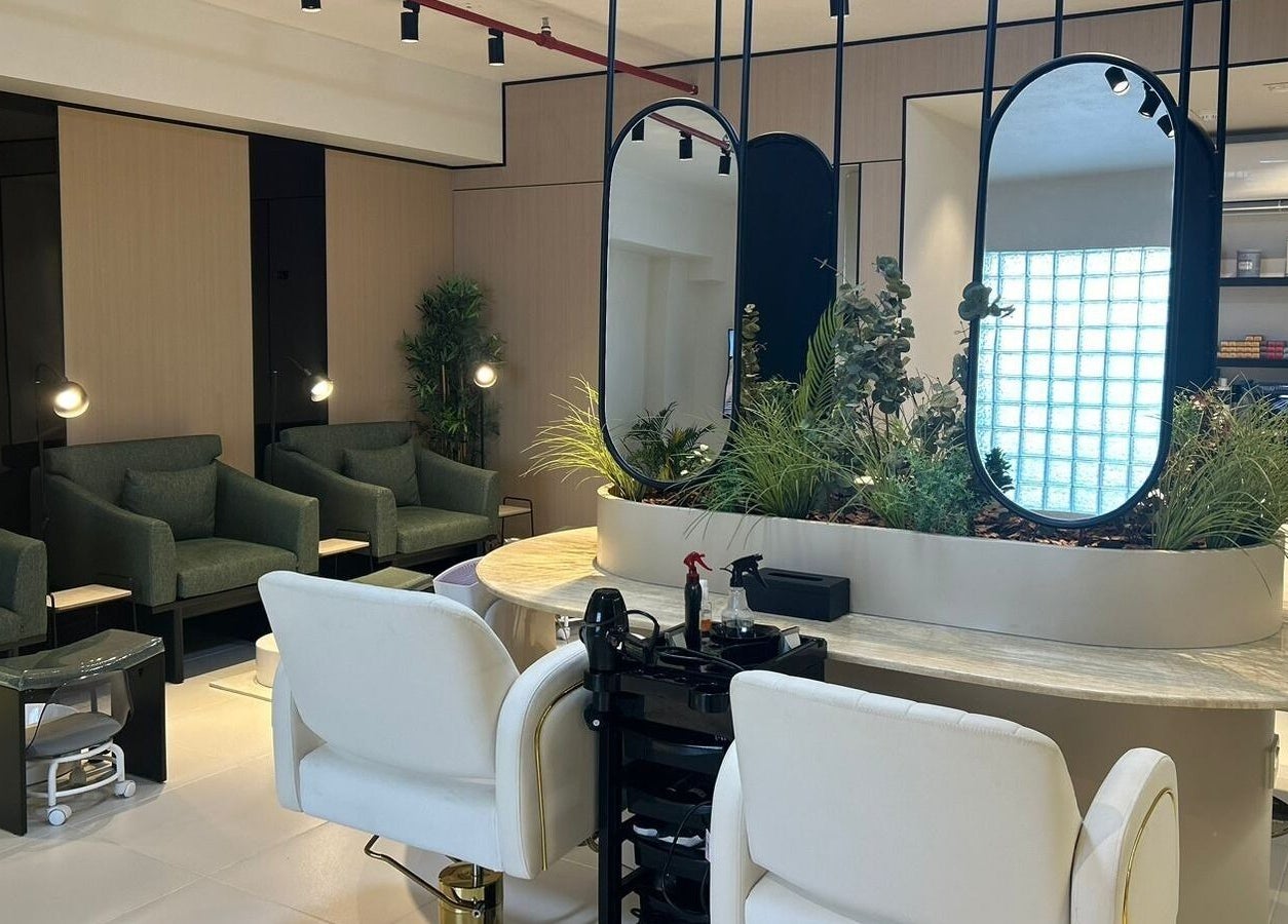 قاعة انتظار فاخرة في صالون Sage Salon، الدمام، المنطقة الشرقية، السعودية، تعرض كراسي مريحة ومرايا أنيقة.