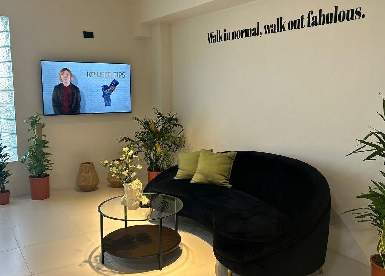 منطقة استقبال أنيقة في صالون سيج، الدمام، المنطقة الشرقية، السعودية مع أريكة فاخرة ونباتات.