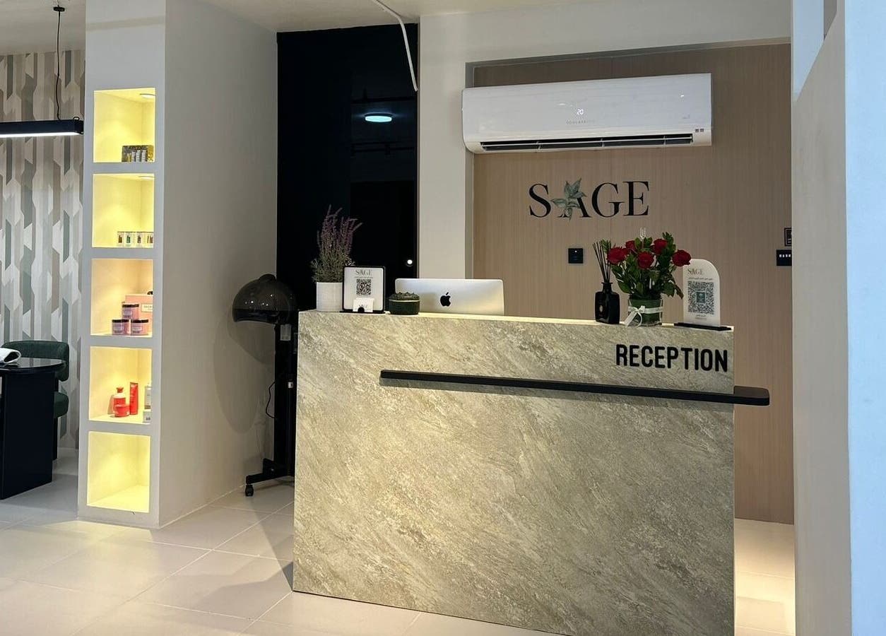 مكتب استقبال عصري في صالون ساج، الدمام، المنطقة الشرقية، يزينه نباتات وزهور.