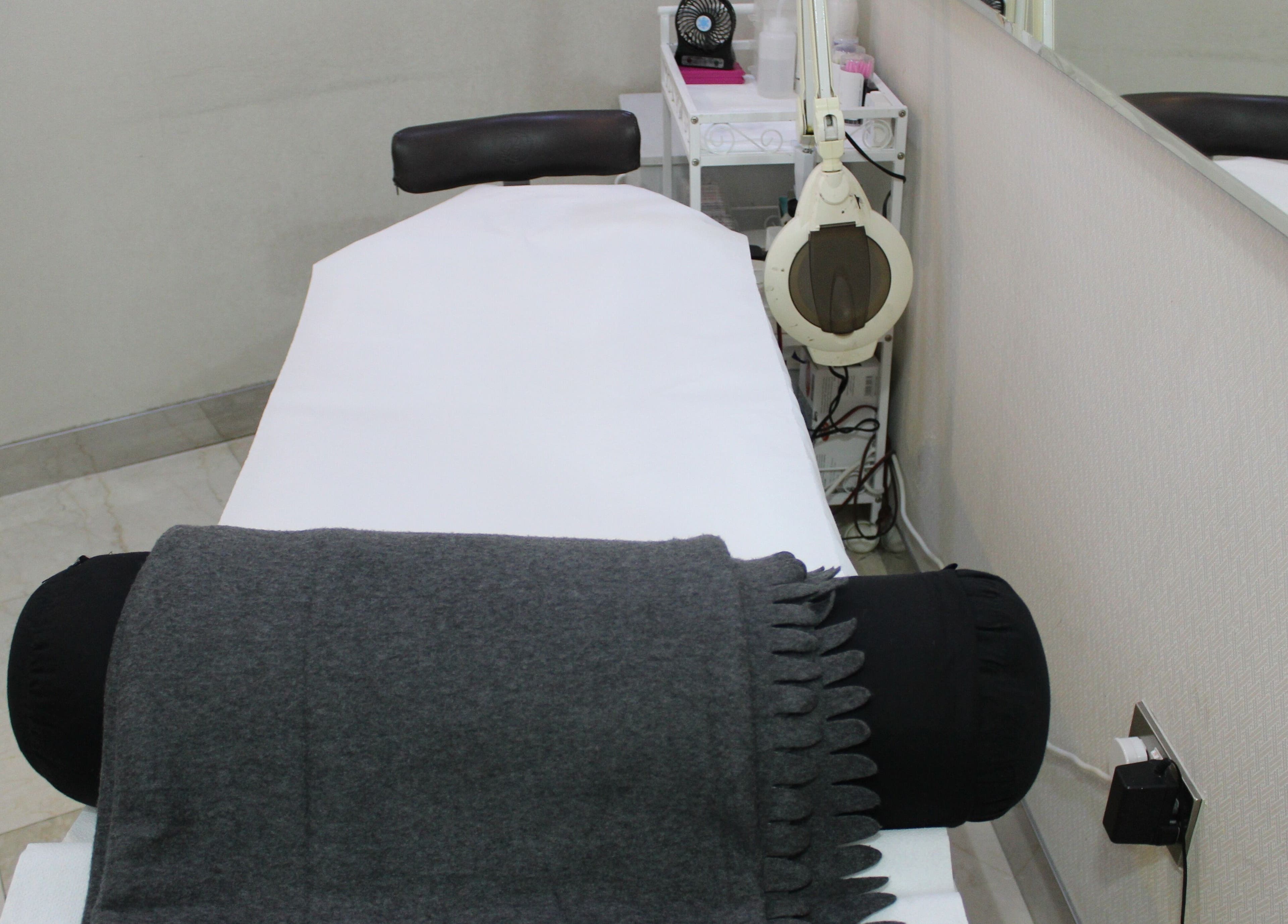 Cozy treatment room at Eyelash Extension Center, Souk Qariyat Al Beri, Abu Dhabi, AE with comfortable bed.