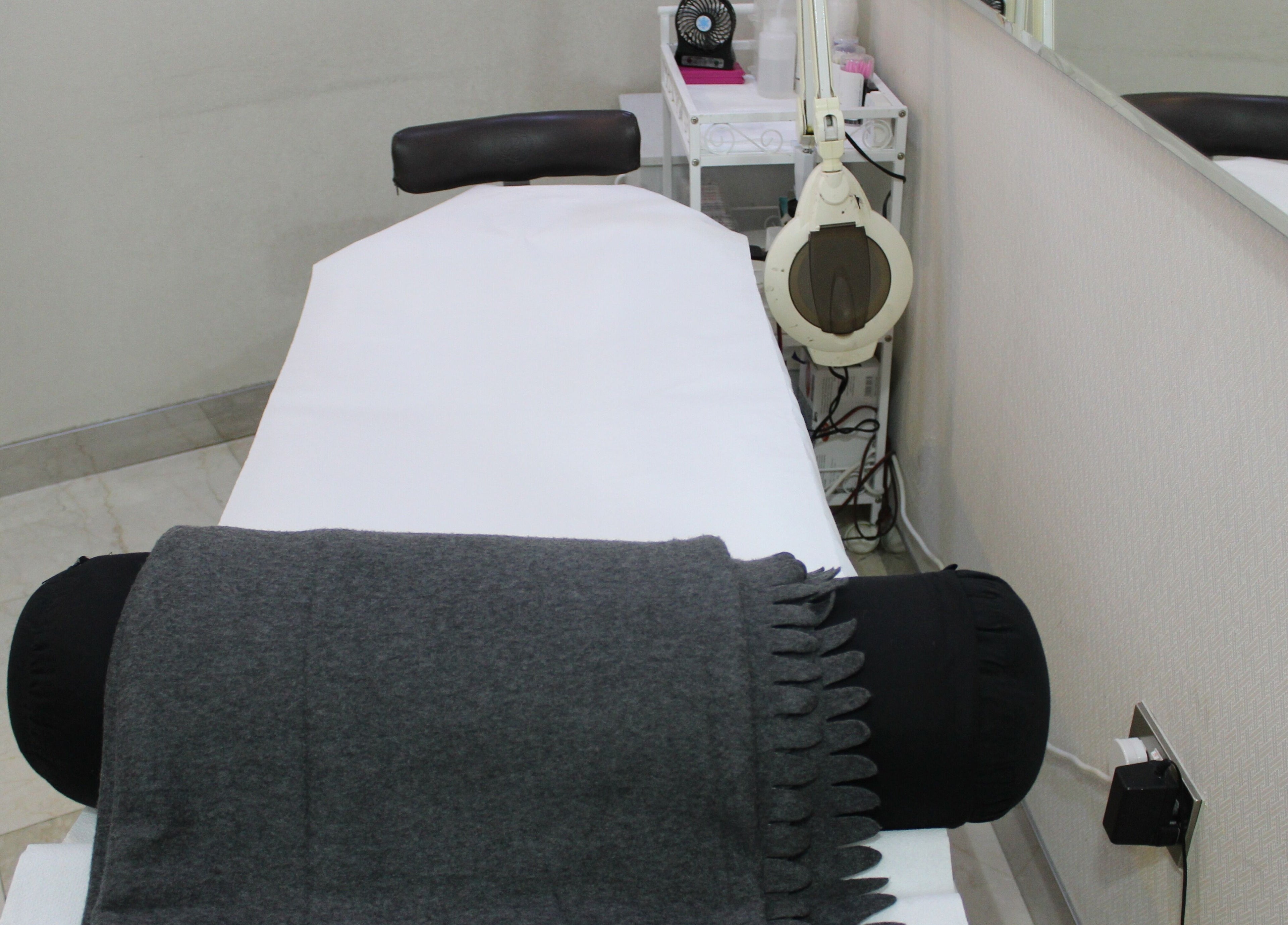 Cozy treatment room at Eyelash Extension Center, Souk Qariyat Al Beri, Abu Dhabi, AE with comfortable bed.