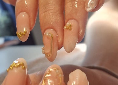 Elegant nail art at Chloe's in Woodville, England, GB featuring gold accents on natural polish.