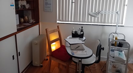Cozy beauty treatment room at Malvern Hills Beauty, Malvern, England, GB, ready for pampering clients.