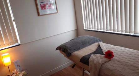 Relaxing spa room at Malvern Hills Beauty, Malvern, England, GB with massage bed and soft lighting.