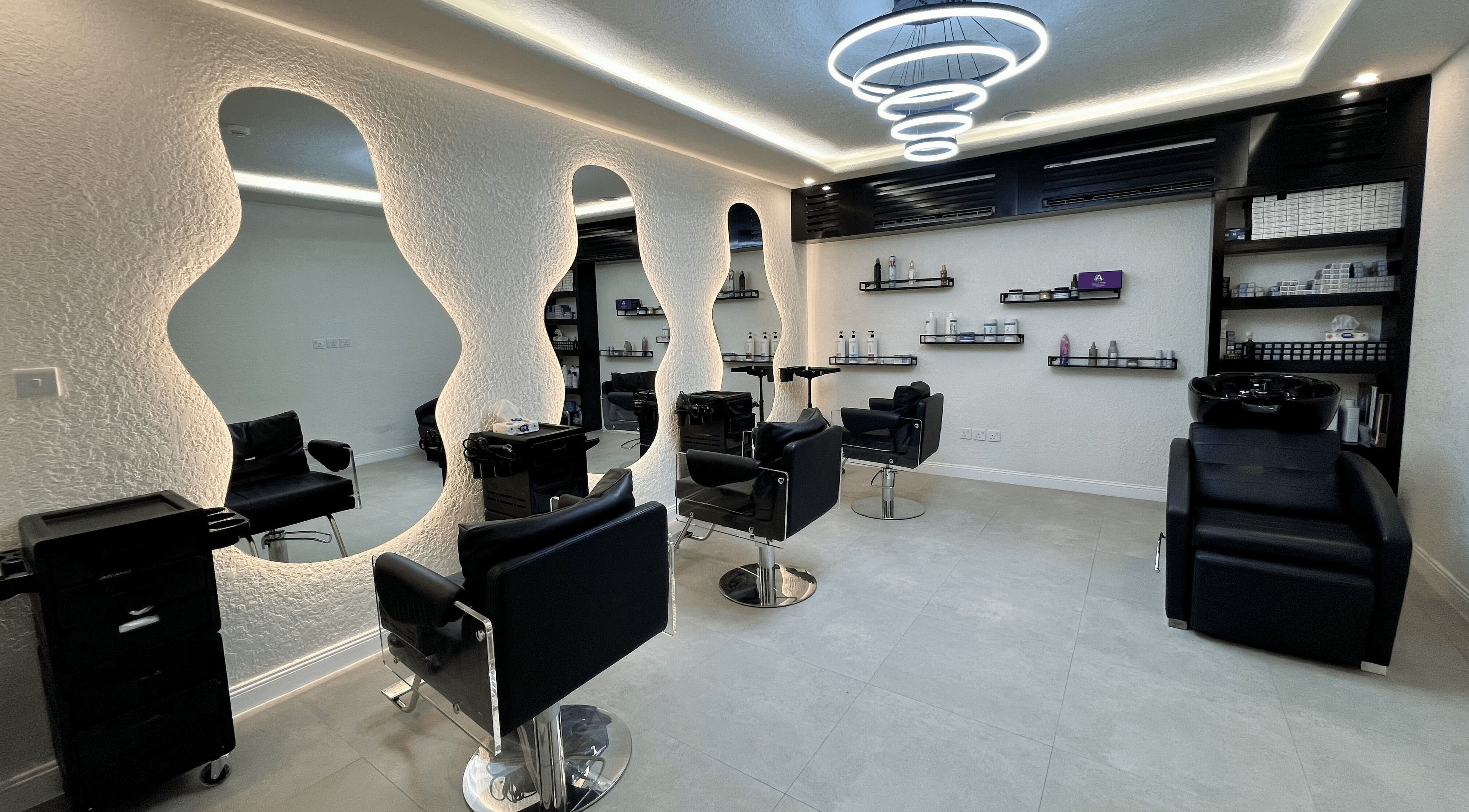 Modern salon interior at Art Care Salon, Riyadh, Riyadh Province, SA with sleek chairs and illuminated mirrors.