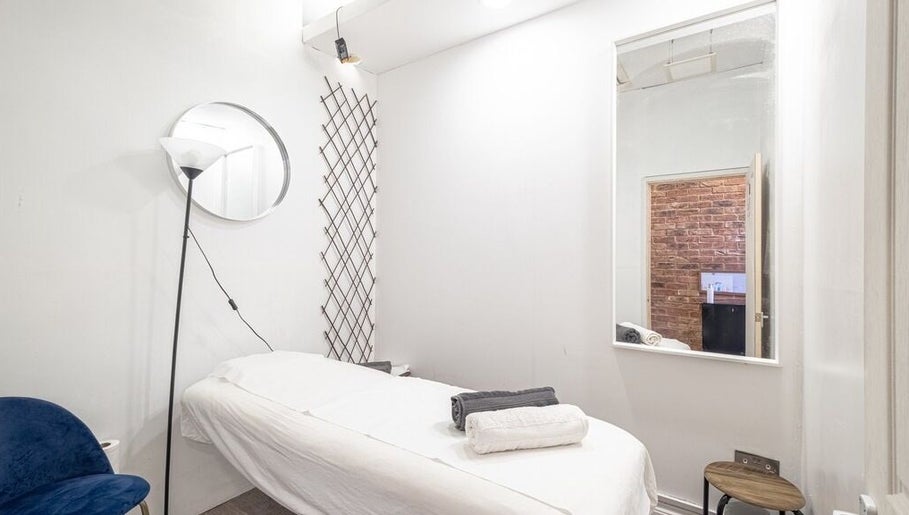 Serene treatment room at The Spa Culture, London, England, GB with massage table and soft lighting.